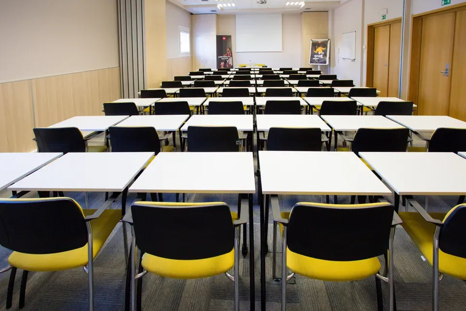 Konferenční sál Hotelu Ibis Plzeň s řadami žlutých židlí